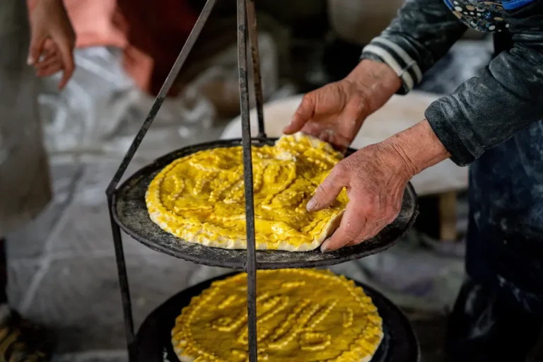 intrepid-travel-armenia-cooking-elderly-women-gata-bread-baking-shutterstock-2707961573