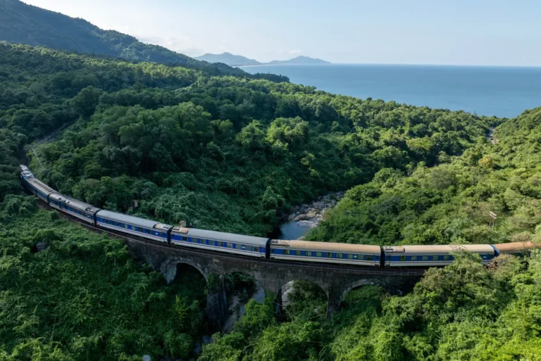 intrepid-travel-vietnam-train-connecting-central-heritage-train-bridge-aerial-view-shutterstock-2522686309